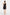 Back view of the black linen mini dress on a model, showing the asymmetric strap detail and the tailored fit.