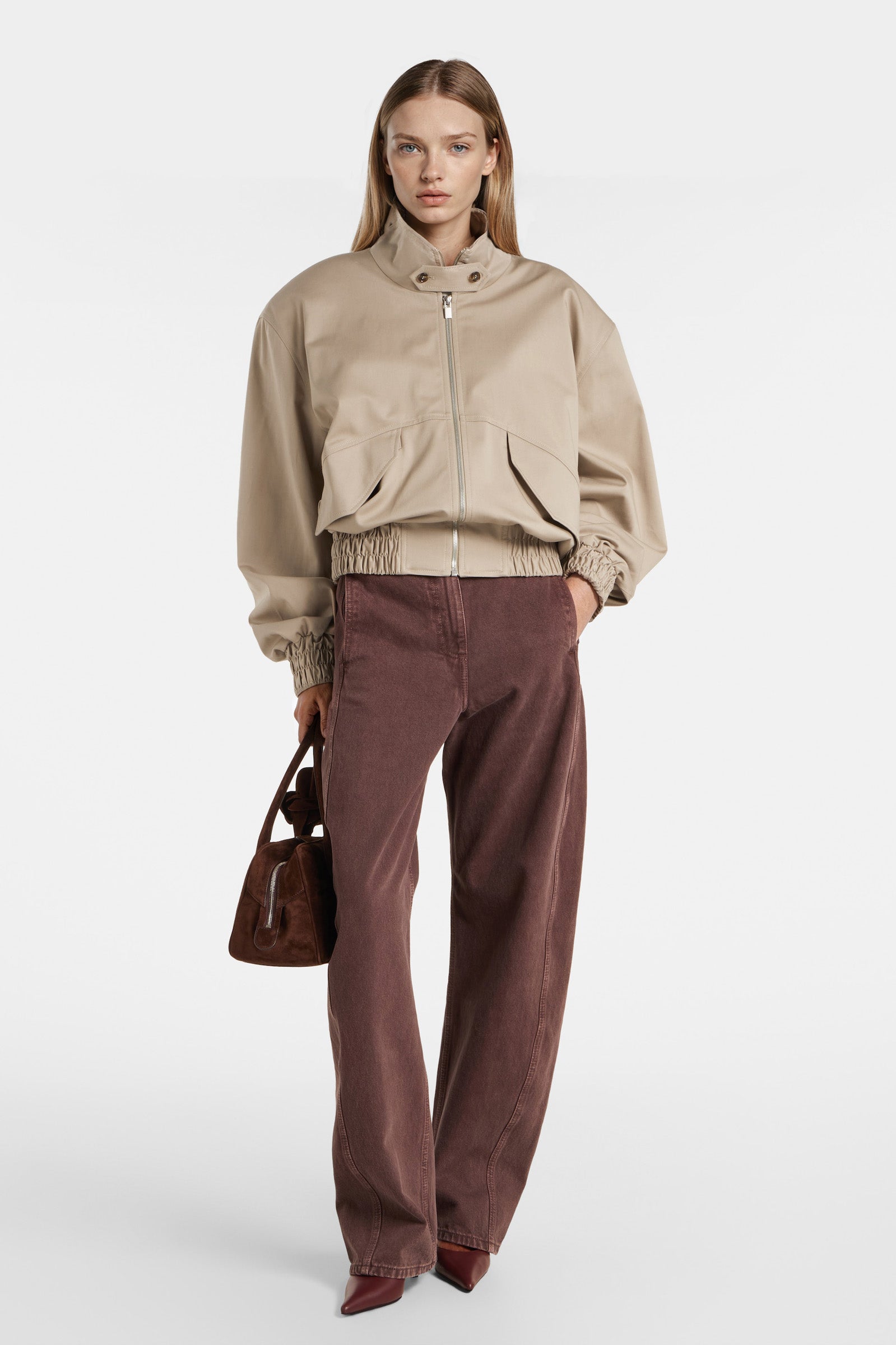Front view of oversized beige bomber jacket with zip closure