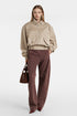 Front view of oversized beige bomber jacket with zip closure