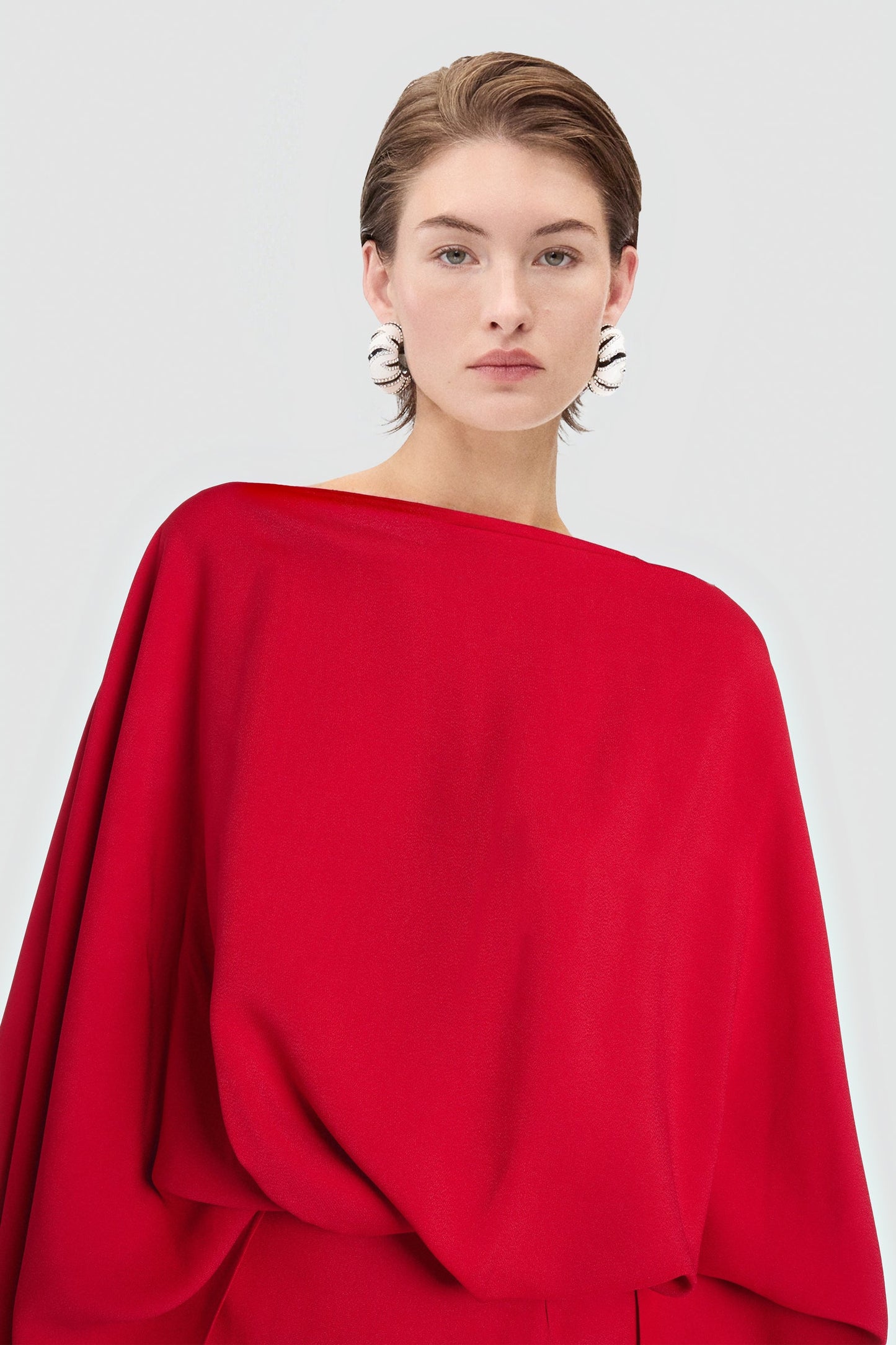 Elegant scarlet dress made in Madrid with dramatic draping.