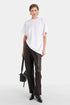 Model wearing white oversized t-shirt with draped front detail.