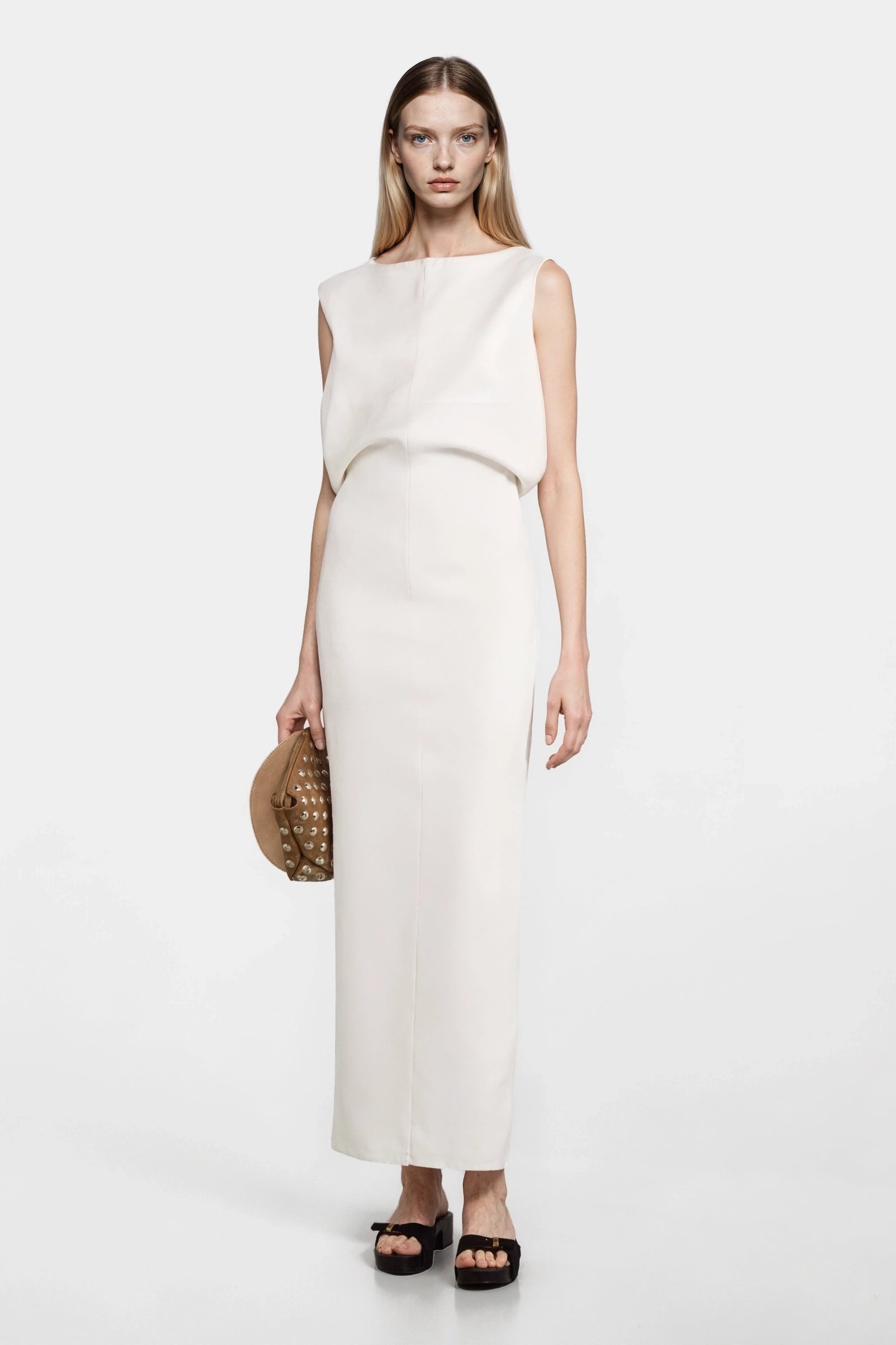 Ivory draped-bodice crepe midi dress styled with platform sandals, front view.
