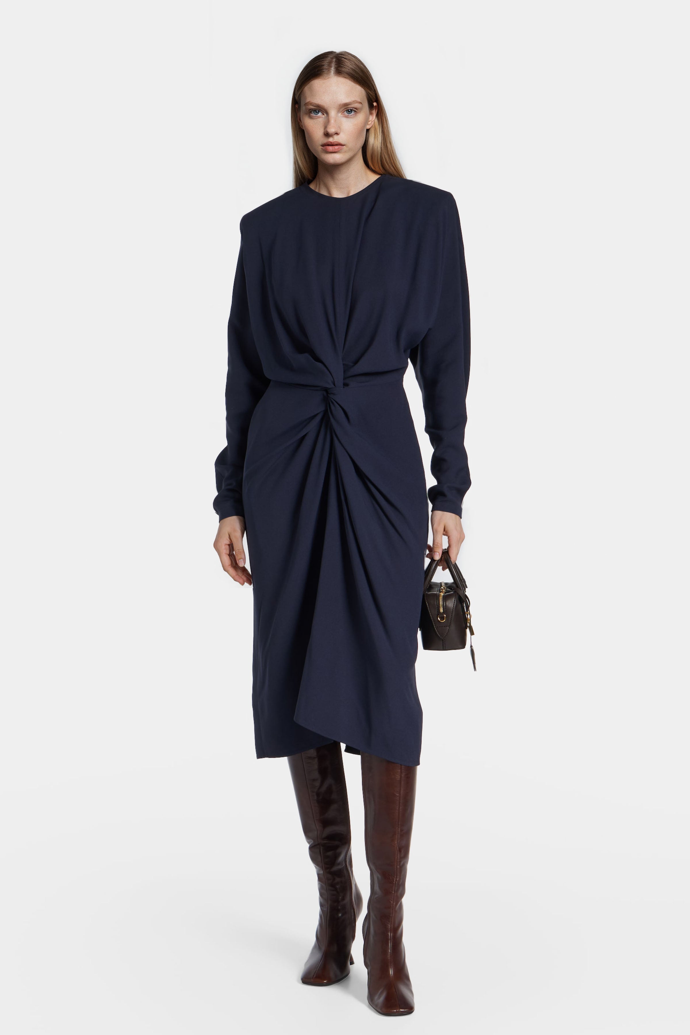 Model wearing Felipe Albernaz Nok Navy Dress – twisted draped front and structured shoulders in navy blue