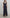 Navy ruffle hem gown video, front and back view, V-neckline, asymmetrical ruffle hem, model showcasing movement and fit.