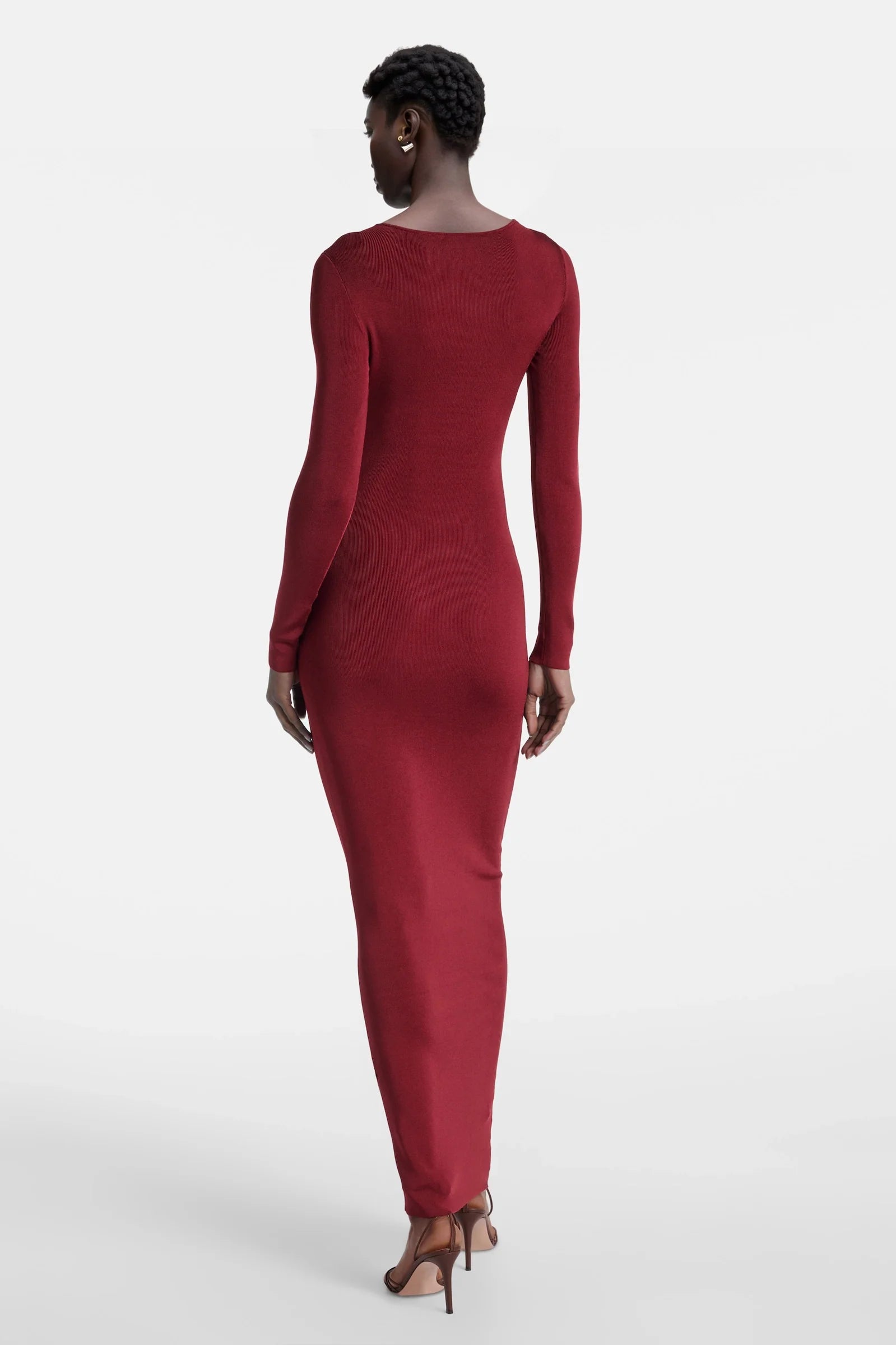 Back view of long red fitted dress with sleeves