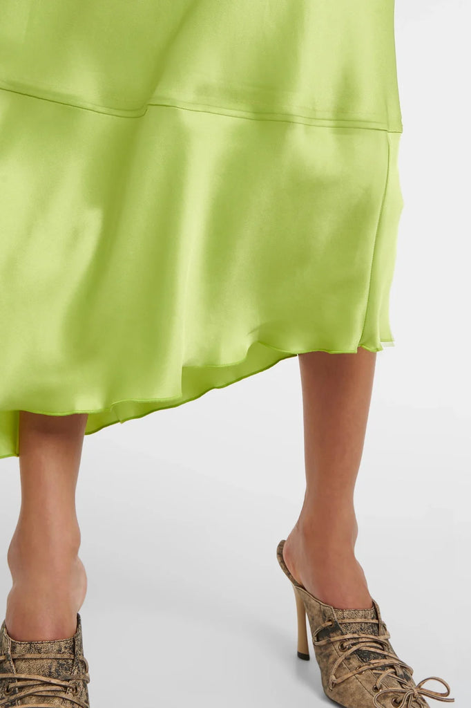 Flattering green satin dresses featuring long sleeves and a cinched waist.