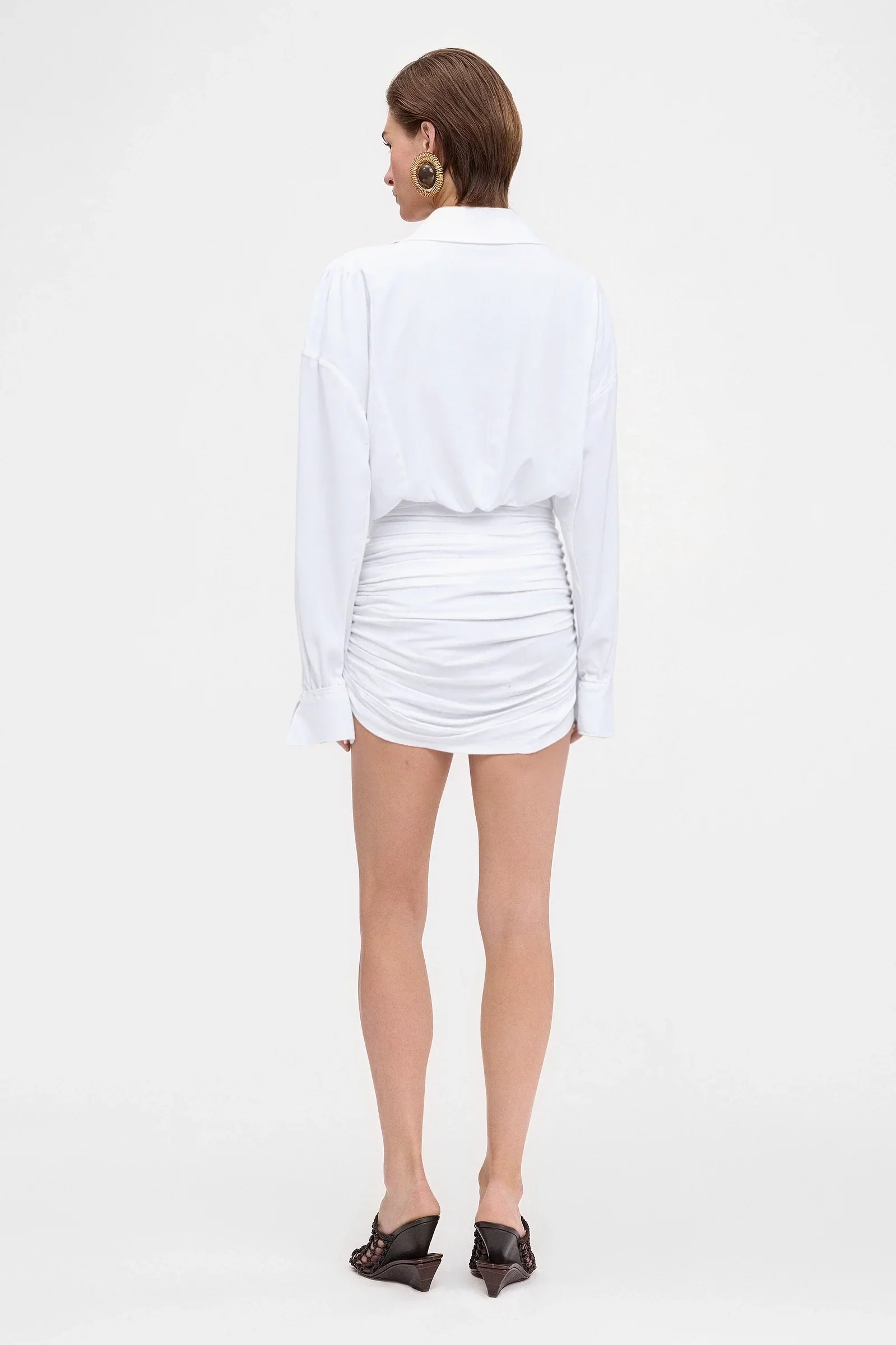 Back view of white ruched shirt-style mini dress – long sleeves
