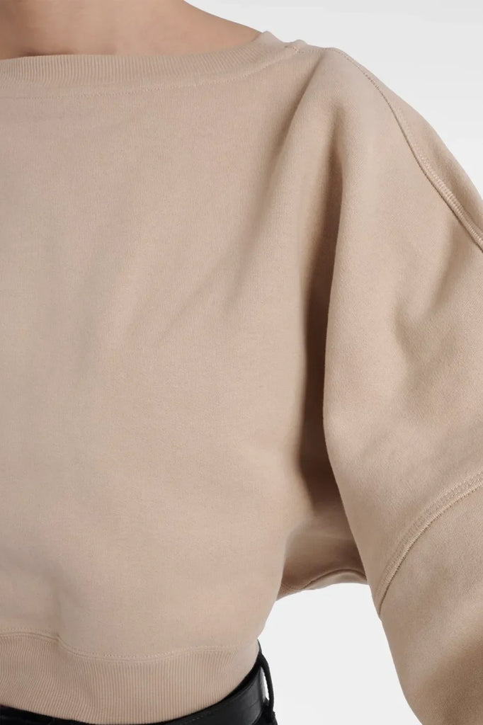 Lisa Cropped Organic Cotton Fleece Sweatshirt in beige with dropped shoulders.