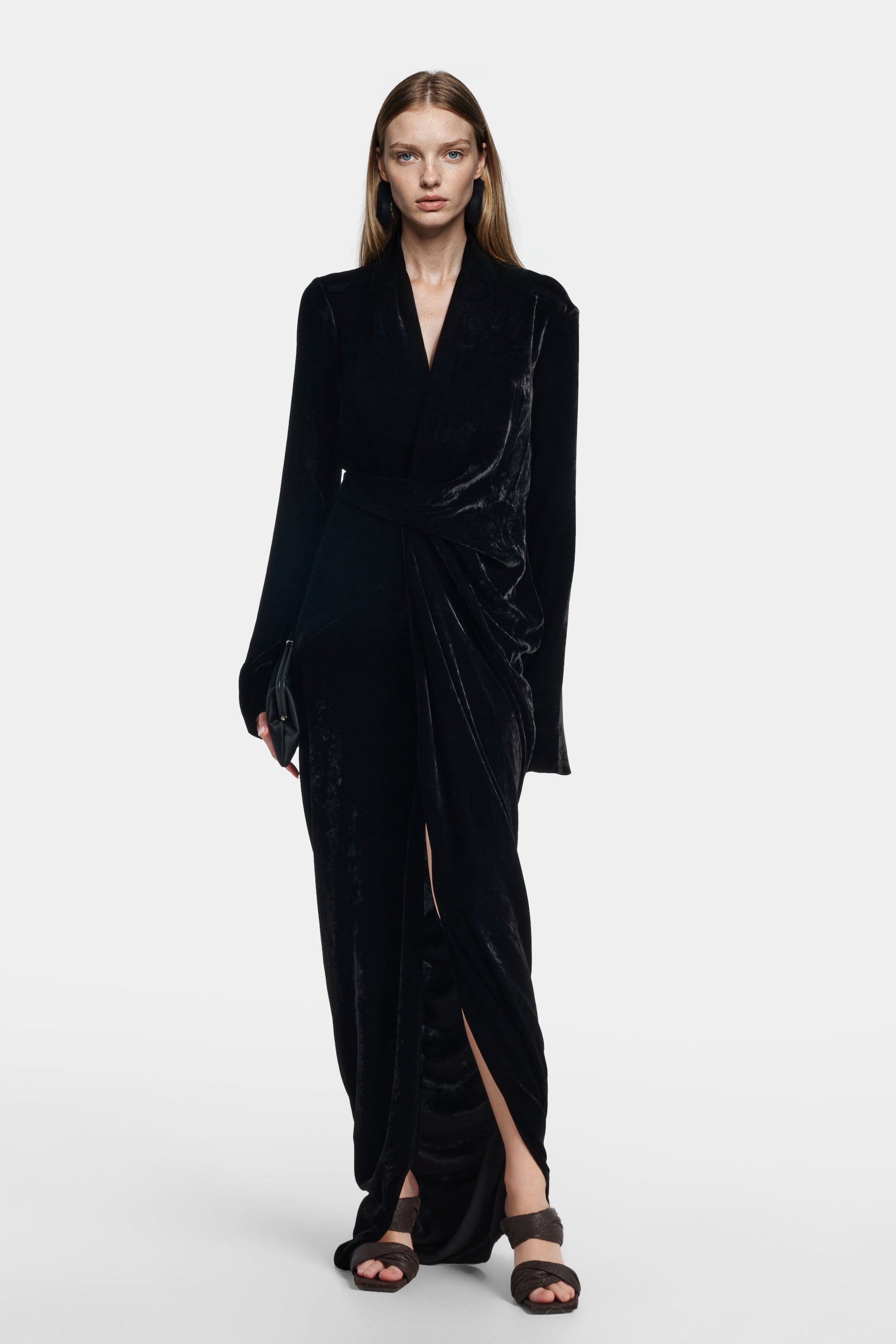 Model wearing Felipe Albernaz Velvet Wrap Black Dress with plunging neckline and wrap silhouette