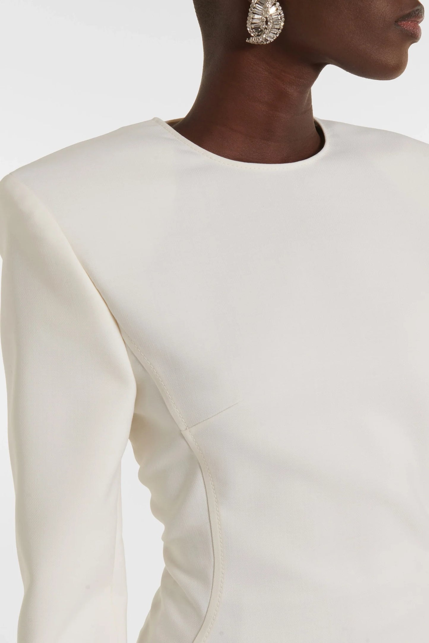 Evening white dress with shoulder pads and statement slit, made in Spain