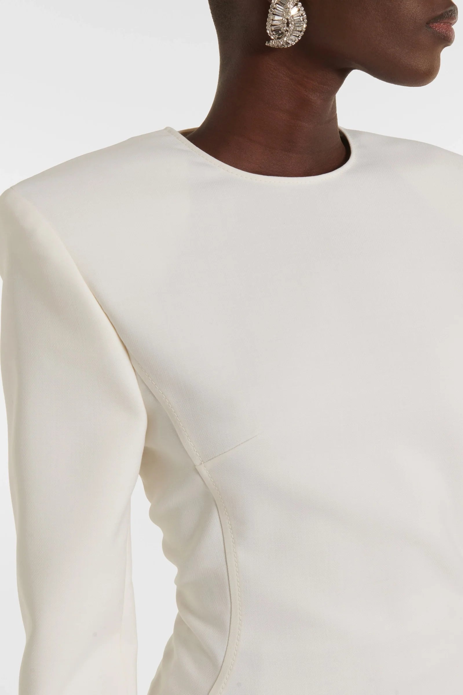 Evening white dress with shoulder pads and statement slit, made in Spain